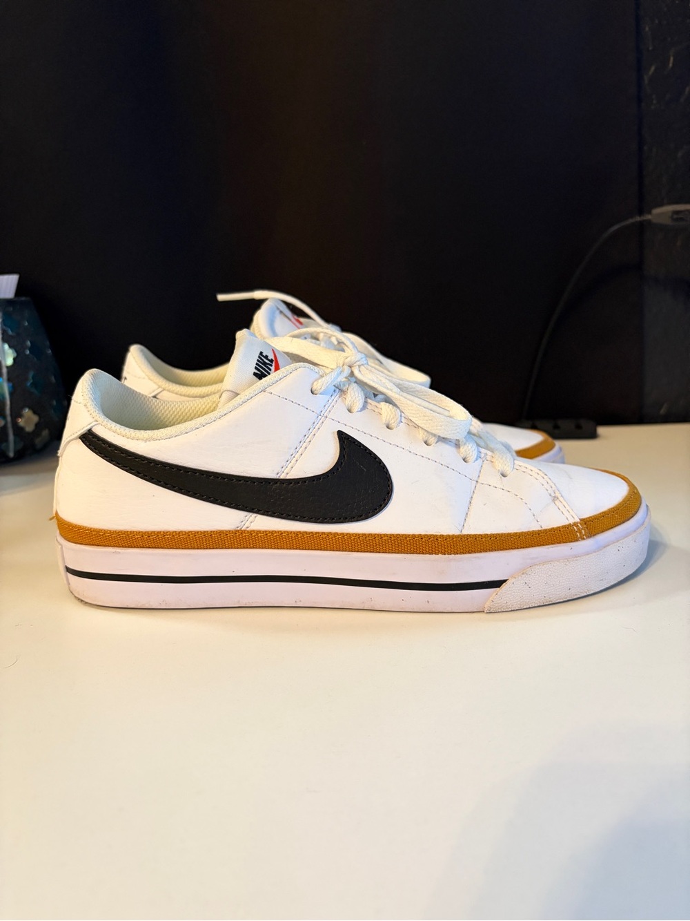 Nike Kids White Sneakers with Black Swoosh and Gold Trim